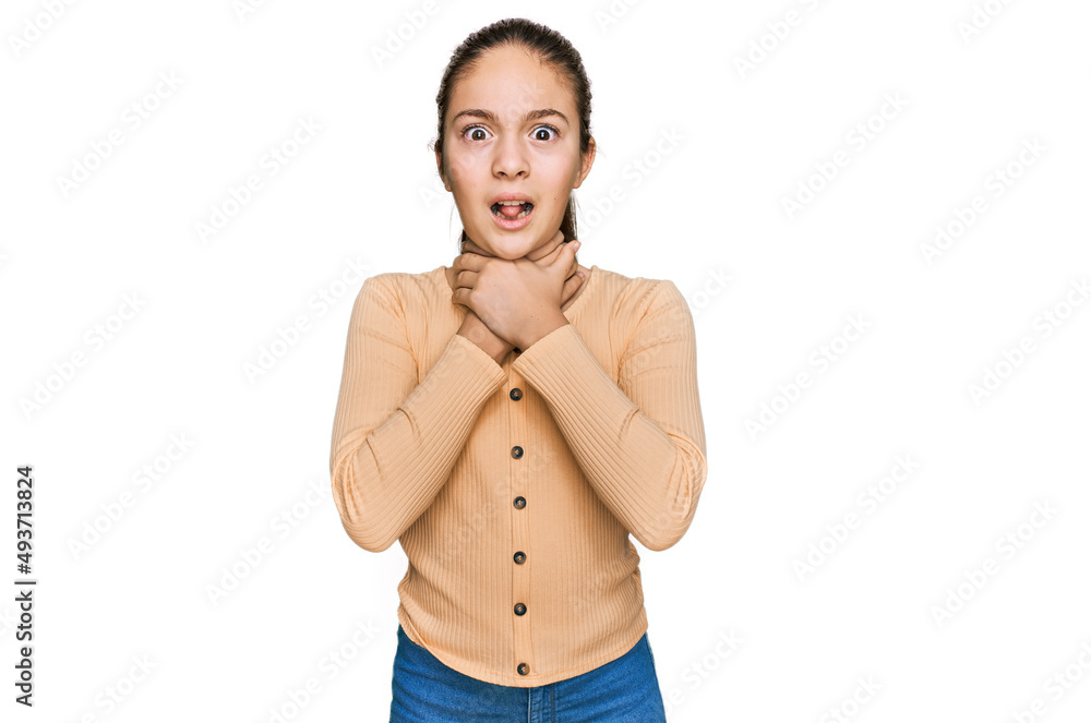 Fototapeta premium Beautiful brunette little girl wearing casual sweater shouting and suffocate because painful strangle. health problem. asphyxiate and suicide concept.
