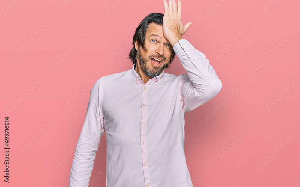 Middle age handsome man wearing business shirt surprised with hand on head for mistake, remember error. forgot, bad memory concept. Middle age handsome man wearing business shirt surprised with hand on head for mistake, remember error. forgot, bad memory concept.