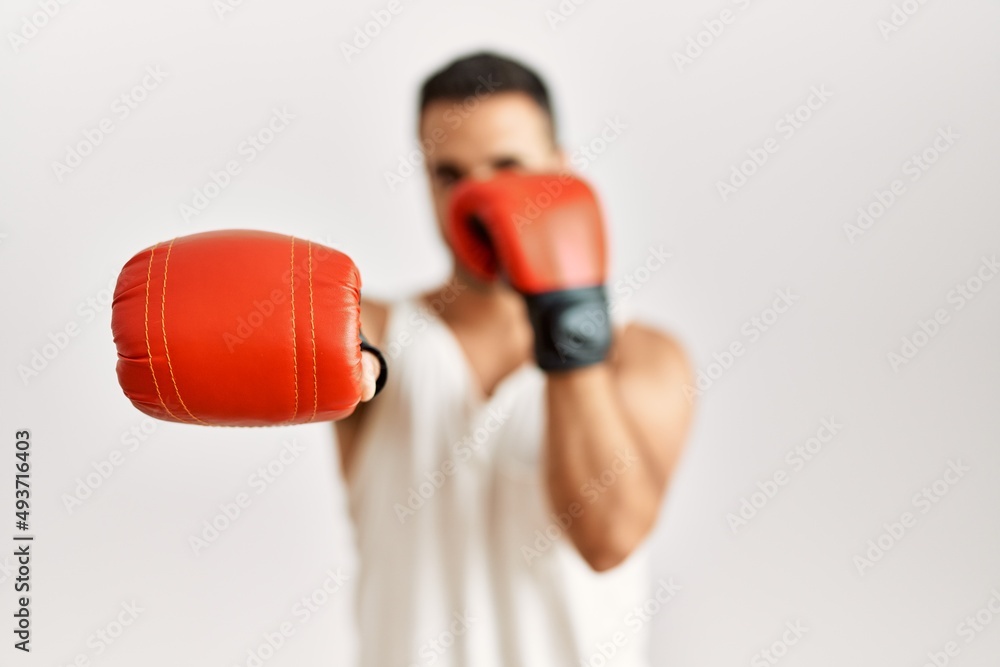Young hispanic man boxing at clothing store Young hispanic man boxing at clothing store