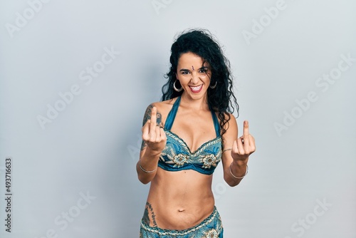 Valokuva Young woman wearing bindi and traditional belly dance clothes showing middle finger doing fuck you bad expression, provocation and rude attitude