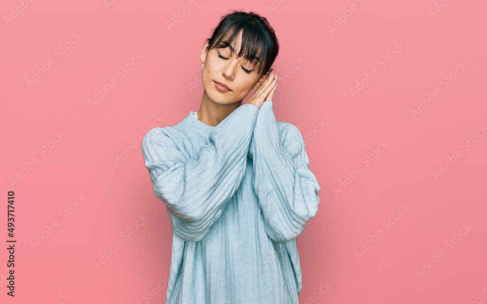 Young hispanic woman wearing casual clothes sleeping tired dreaming and posing with hands together while smiling with closed eyes. Young hispanic woman wearing casual clothes sleeping tired dreaming and posing with hands together while smiling with closed eyes.