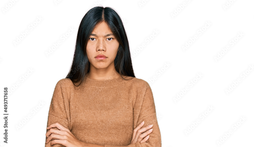 Beautiful young asian woman wearing casual winter sweater skeptic and nervous, disapproving expression on face with crossed arms. negative person. Beautiful young asian woman wearing casual winter sweater skeptic and nervous, disapproving expression on face with crossed arms. negative person.