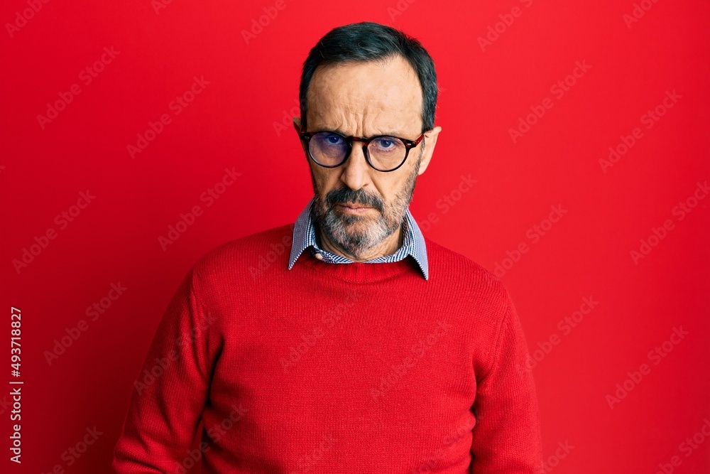 Fototapeta premium Middle age hispanic man wearing casual clothes and glasses skeptic and nervous, frowning upset because of problem. negative person.