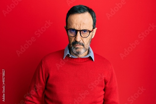 Middle age hispanic man wearing casual clothes and glasses skeptic and nervous, frowning upset because of problem. negative person. © Krakenimages.com