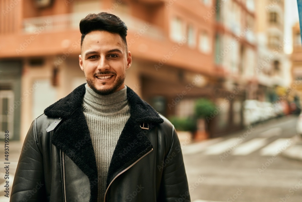 Young arab man smiling happy standing at the city. Young arab man smiling happy standing at the city.