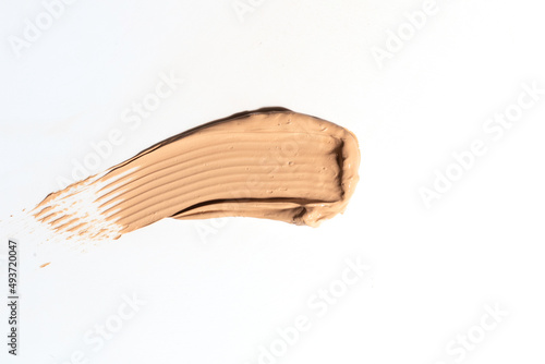 Creamy foundation smeared on white background. Isolated. Beauty and fashion conception.