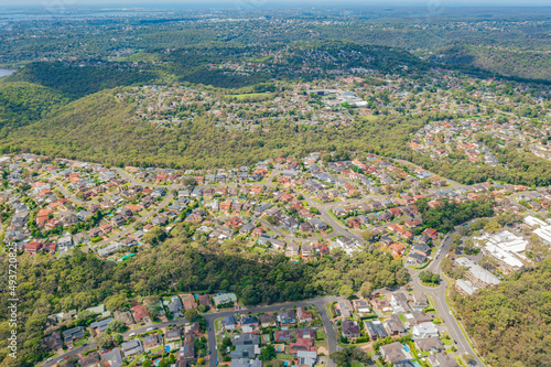 Aerial view of streets, cul-de-sacs, houses and rooftops in the suburb of Menai in Sutherland Shire, Sydney, Australia looking east toward Bangor 