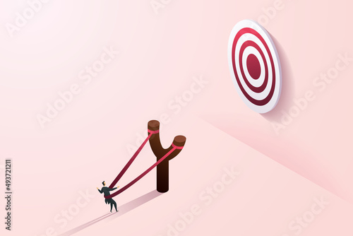 Businessman in slingshot prepares to dash towards a target