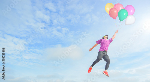 Colorful balloons, men floating with balloons. sportman holding on to balloons above a sky trying to escape hand bursting his balloon concept for challenge or bullying