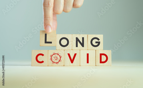 Long covid, post covid concept. Long-term effects of coronavirus. Chronic fatigue or weakness, feeling tired easily. Medical, treatment for long covid symstoms, tips for recovery..Wooden cube blocks. photo