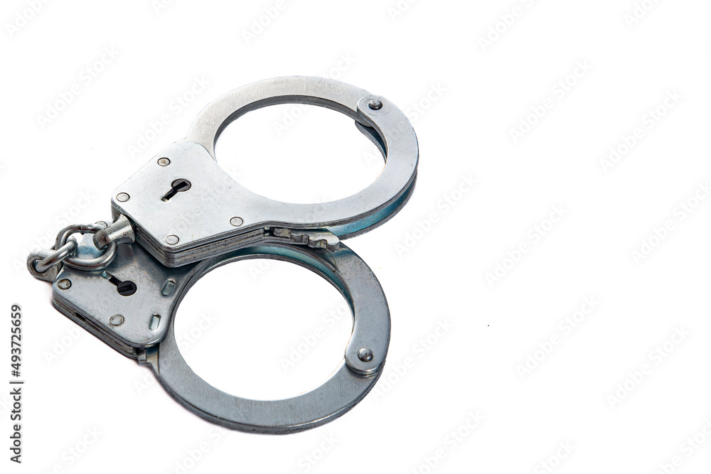 Metal handcuffs on a white isolated background, copy space Metal handcuffs on a white isolated background, copy space