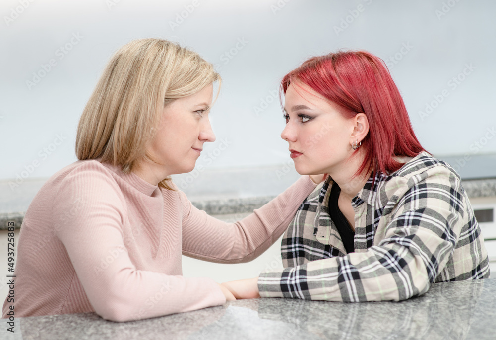 Careful mother talks with her teen daughter about her problems. Teenagers problem concept Careful mother talks with her teen daughter about her problems. Teenagers problem concept
