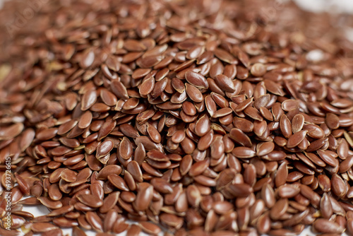 A close-up photo of flax, you can see the texture of the seeds, the whole background is filled with seeds