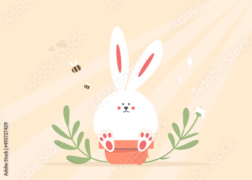 Happy Easter! Easter bunny or rabbit sitting on the eggs basket. Sunbeam and spring nature. Tender colors.
