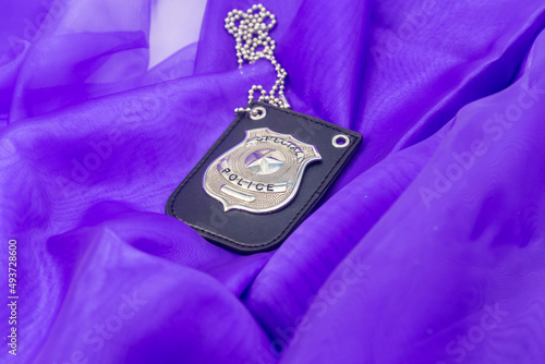 Police badge on purple background
