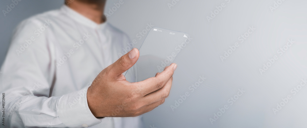 Future transparent glass phone Technology. Mock-up blank screen futuristic super slim transparent smartphone in business person hand with copy space. Future technology communication equipment. - obrazy, fototapety, plakaty 