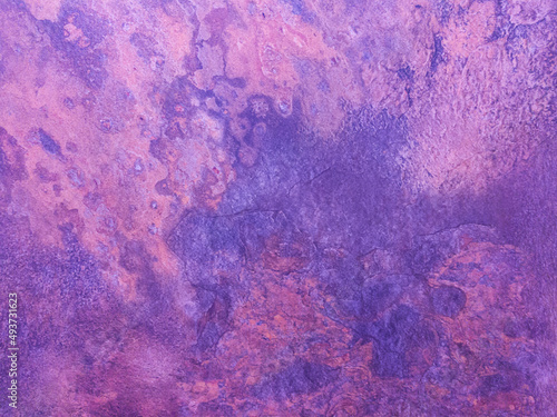 A rusty purple metal wall with spots and scuffs. Vintage background with texture. Rough surface. 