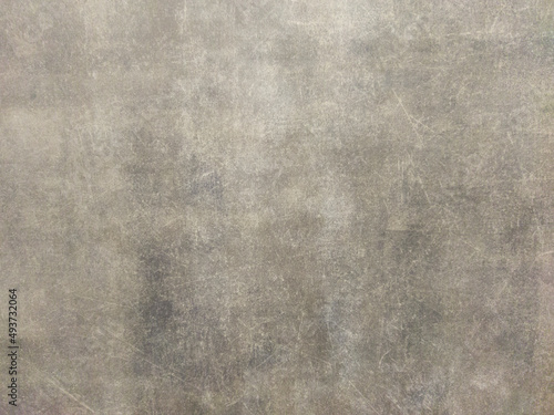 Rusty gray metal wall with scratches and scuffs. Vintage background with texture. Rough surface.
