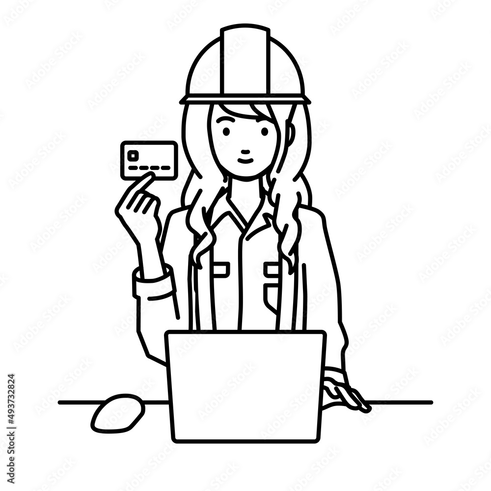 デスクで座ってPCを使いながらクレジットカードを手に持っている工事現場の女性