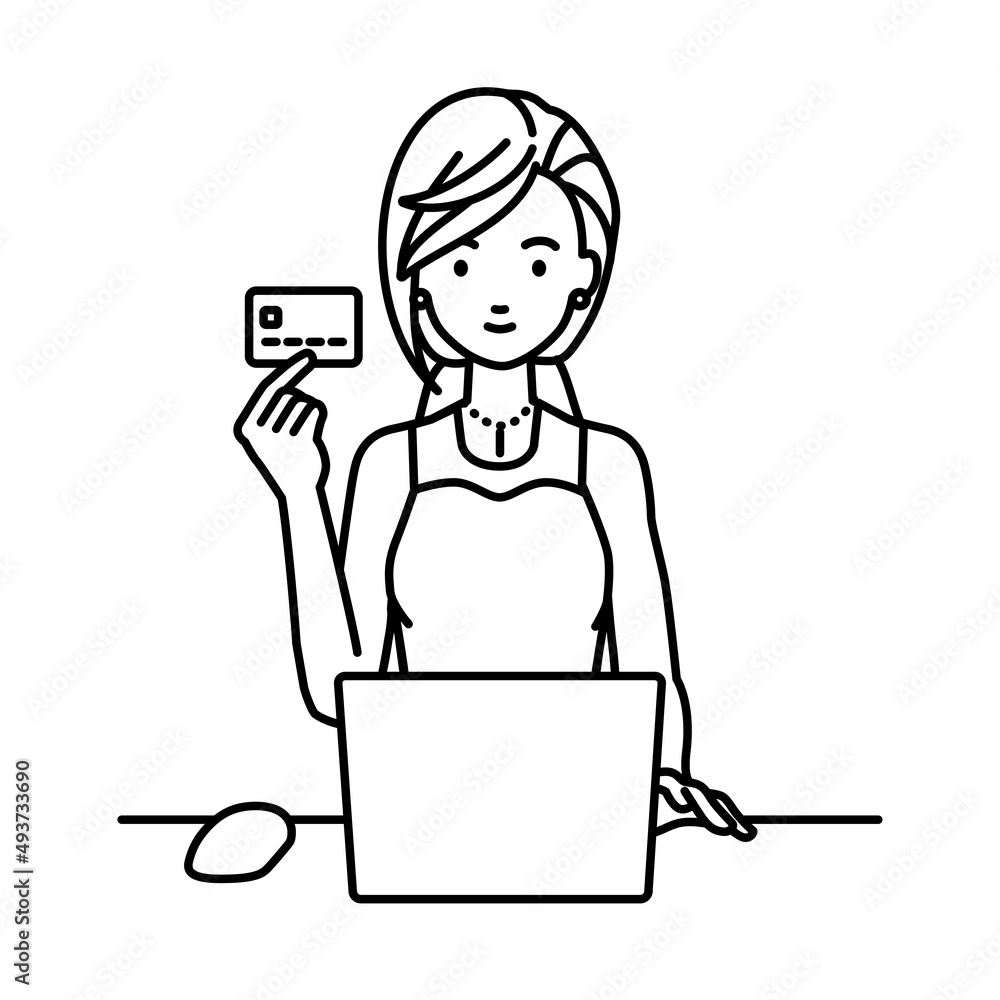 デスクで座ってPCを使いながらクレジットカードを手に持っているドレスの女性
