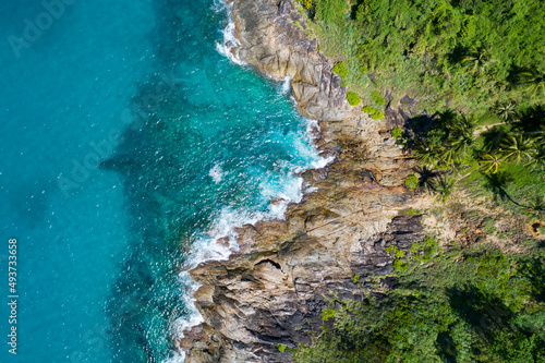 Aerial view of sea crashing waves White foaming waves on seashore rocks Top view Rocky coast mountain landscape view Nature background