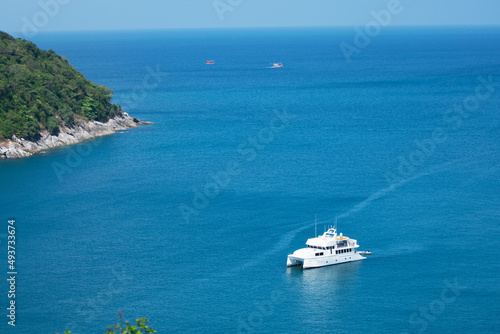 Aerial View of Yacht boat or sailboat luxury boat in tropical summer sea. Transportation and travel background Beautiful sea in summer season at Phuket island Thailand © panya99