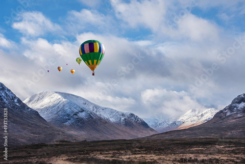 Digital composite image of hot air balloons flying over Majestic beautiful Winter landscape image of Lost Valley in Scotland © veneratio