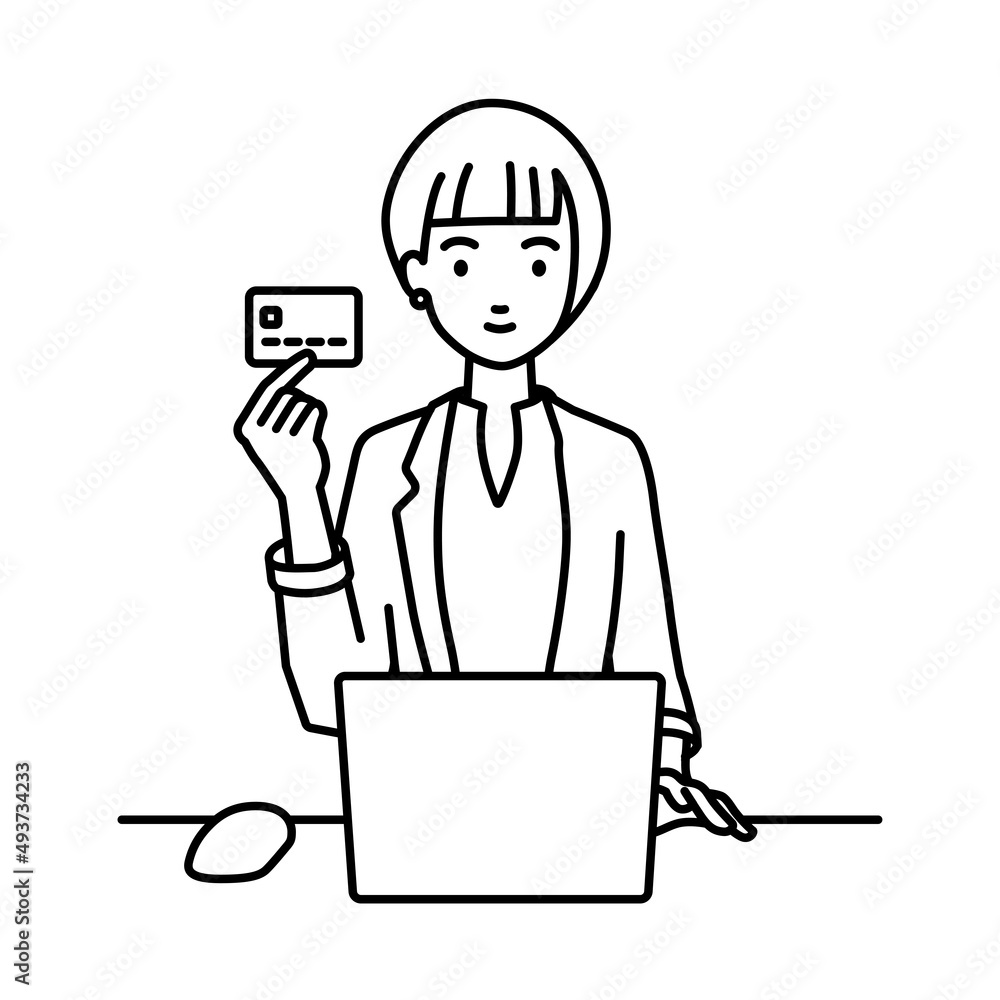 デスクで座ってPCを使いながらクレジットカードを手に持っているジャケットの女性 デスクで座ってPCを使いながらクレジットカードを手に持っているジャケットの女性