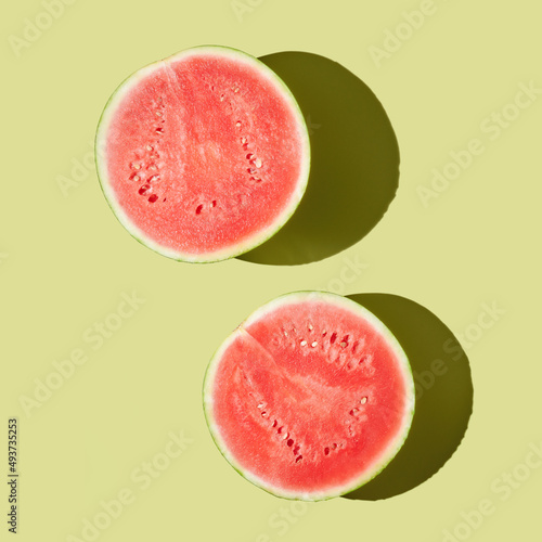 Cut watermelon o ngreen pastel background photo