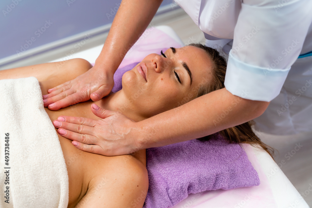 Facial massage. A woman is given a massage in a beauty salon. Close-up. Facial massage. A woman is given a massage in a beauty salon. Close-up.