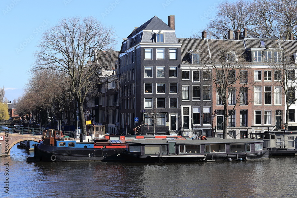 Amsterdam Amstel River View with Traditional Architecture, House Boats and Bridge, Netherlands