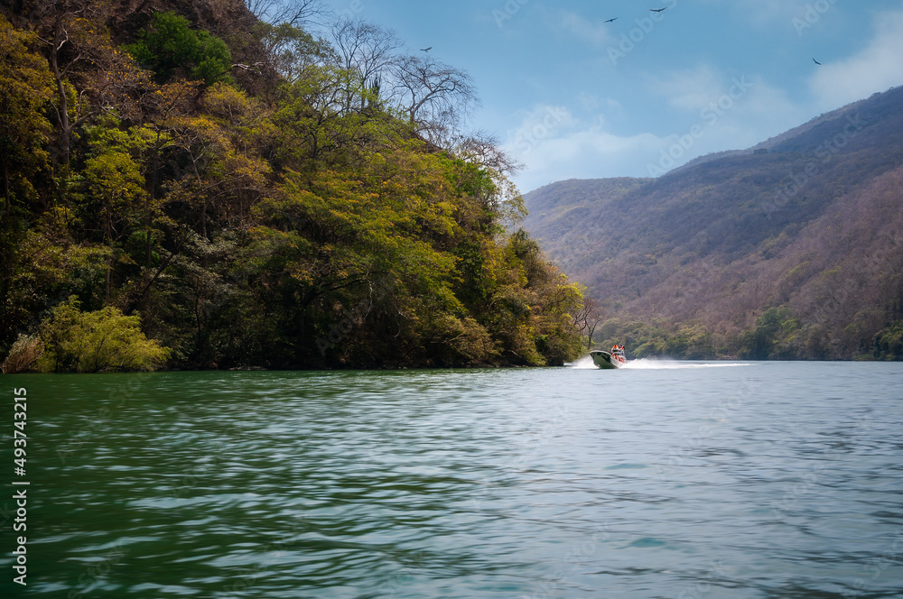 Sumidero Canyon is a deep natural canyon on Grijalva River in Chiapas, Southern Mexico. The Canyon's vertical walls are covered with medium deciduous rainforest. A boat tour here is a popular choice.