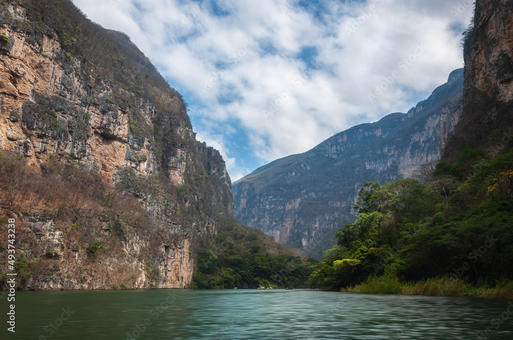 Sumidero Canyon is a deep natural canyon located on the Grijalva River in Chiapas Mexico. The canyon is 35 million years old and its vertical walls can reach up to 1,000 meters. Sumidero Canyon is a deep natural canyon located on the Grijalva River in Chiapas Mexico. The canyon is 35 million years old and its vertical walls can reach up to 1,000 meters.