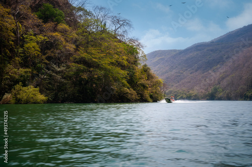 Sumidero Canyon is a deep natural canyon on Grijalva River in Chiapas  Southern Mexico. The Canyon s vertical walls are covered with medium deciduous rainforest. A boat tour here is a popular choice.