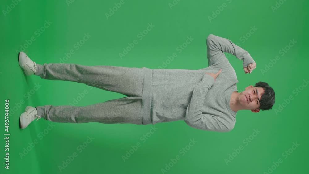 Full Body Of Smiling Asian Man Pointing Bicep While Standing In Front Of Green Screen Background
Full Body Of Smiling Asian Man Pointing Bicep While Standing In Front Of Green Screen Background