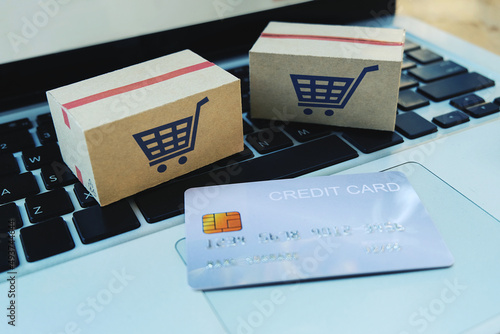 Shopping online e-comerce,Parcel boxes and credit card on a laptop.