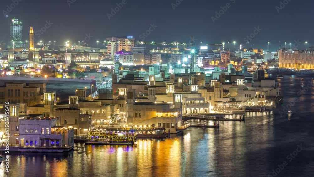 Dubai creek landscape night timelapse with boats and ship near waterfront Dubai creek landscape night timelapse with boats and ship near waterfront