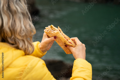 A woman eating a tasty sandwich. Eating out with fast and healthy food photo