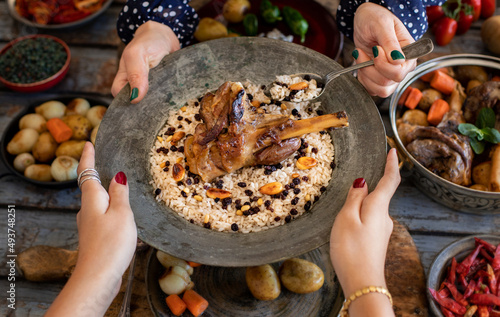 A plate of grilled lamb with pilau with spice, small plates, carrots. photo