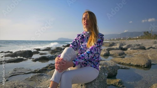Woman relaxin on the sea beach in spring time photo