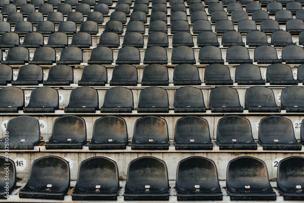 Empty stands and seats for fans and fans in the open-air stadium. Lack of fans during the pandemic. Empty stands and seats for fans and fans in the open-air stadium. Lack of fans during the pandemic.