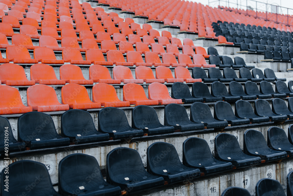Empty stands and seats for fans and fans in the open-air stadium. Lack of fans during the pandemic.