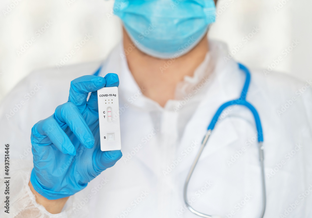 Hand in protective glove holds rapid antigen test for covid-19 in laboratory. Quick swab method to test Coronavirus. PCR Hand in protective glove holds rapid antigen test for covid-19 in laboratory. Quick swab method to test Coronavirus. PCR