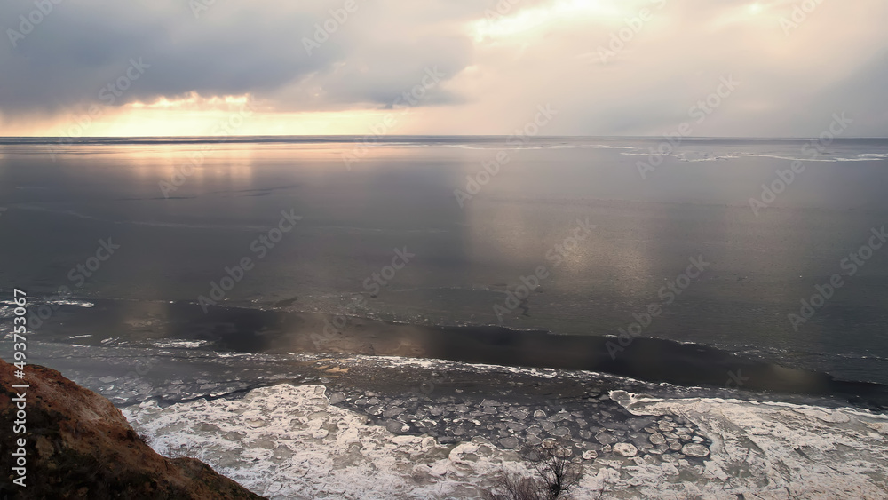 Obraz premium The drone flies over canyons and a frozen river or sea. Photo from a bird's eye view. View from above.