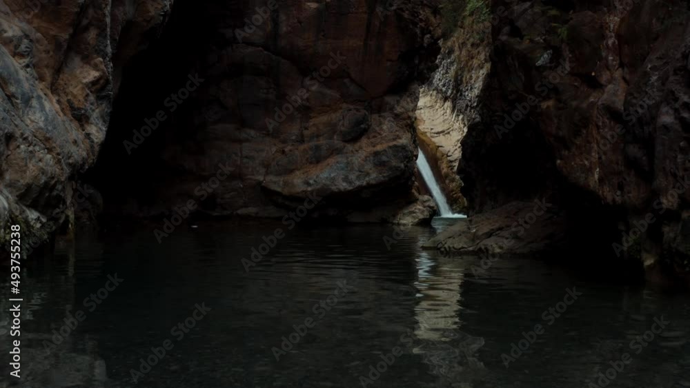 Aerial view of a water flowing into the river in between the mountains at Noori waterfall,Pakistan Aerial view of a water flowing into the river in between the mountains at Noori waterfall,Pakistan