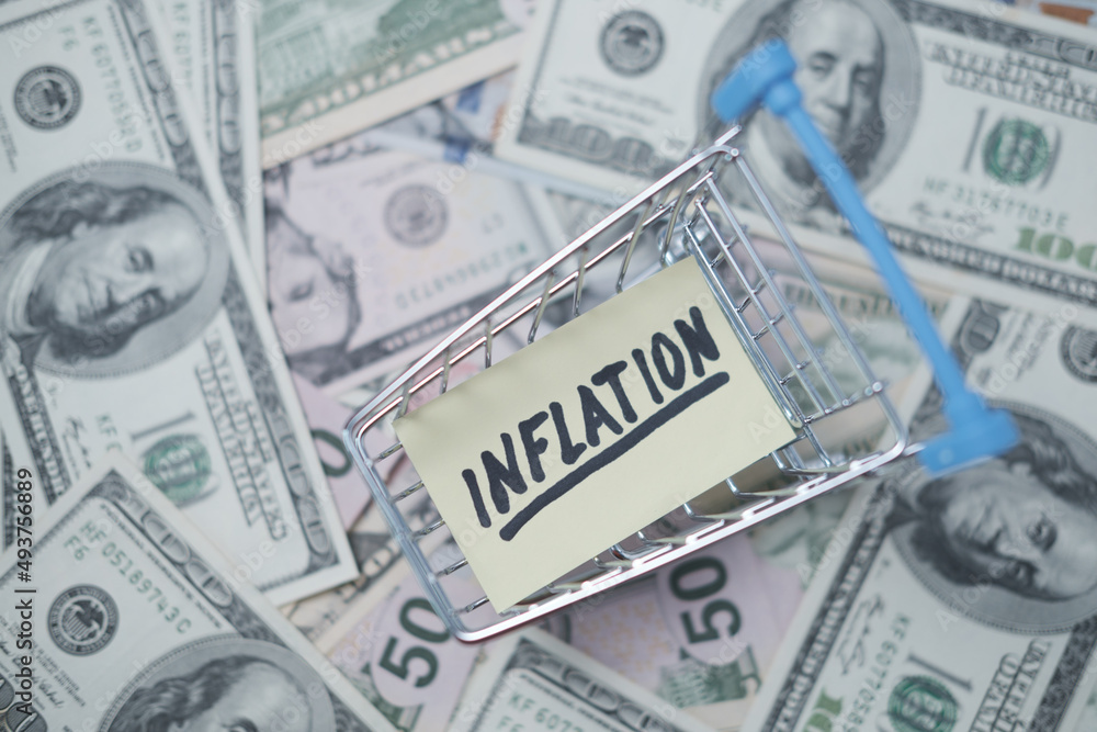 Shopping cart with inflation poster on the background of money. Shopping cart with inflation poster on the background of money.