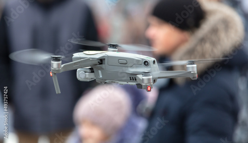 Drone in flight on the background of people. © schankz