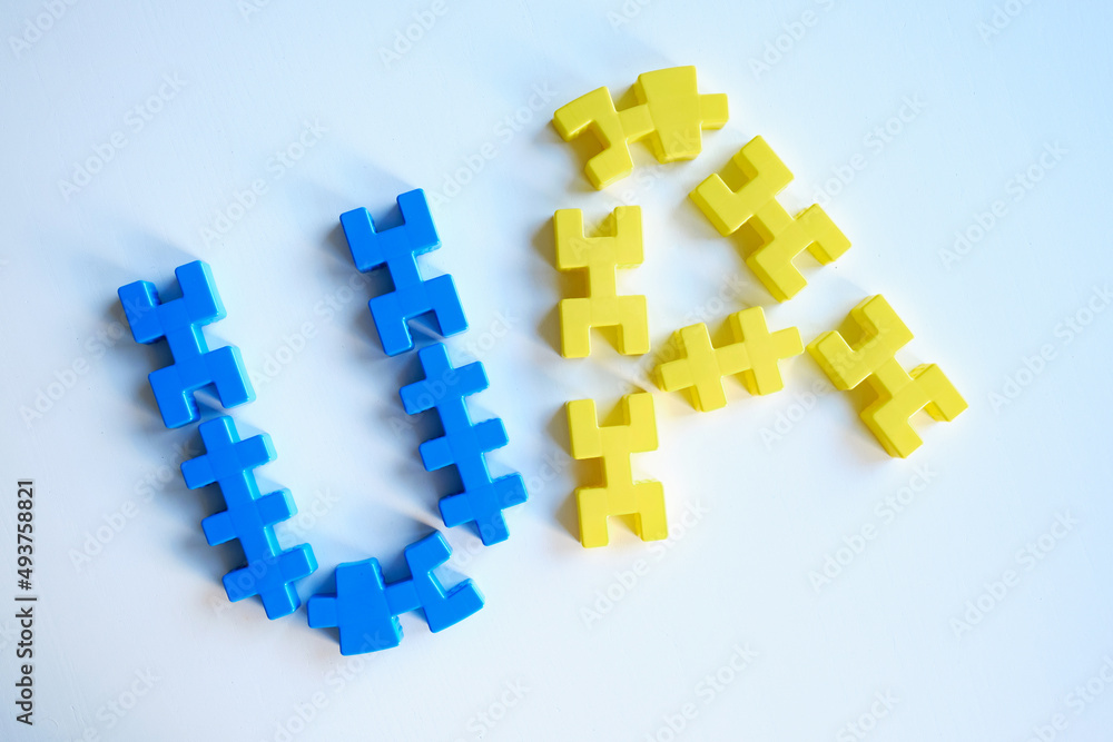 Puzzle letters UA yellow-headed on a light background. Independence of Ukraine. Flag. Ukraine love concept Puzzle letters UA yellow-headed on a light background. Independence of Ukraine. Flag. Ukraine love concept