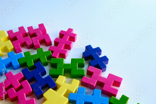 Colored puzzles on a light background. Logic games constructor for children and adults. Bright background and texture