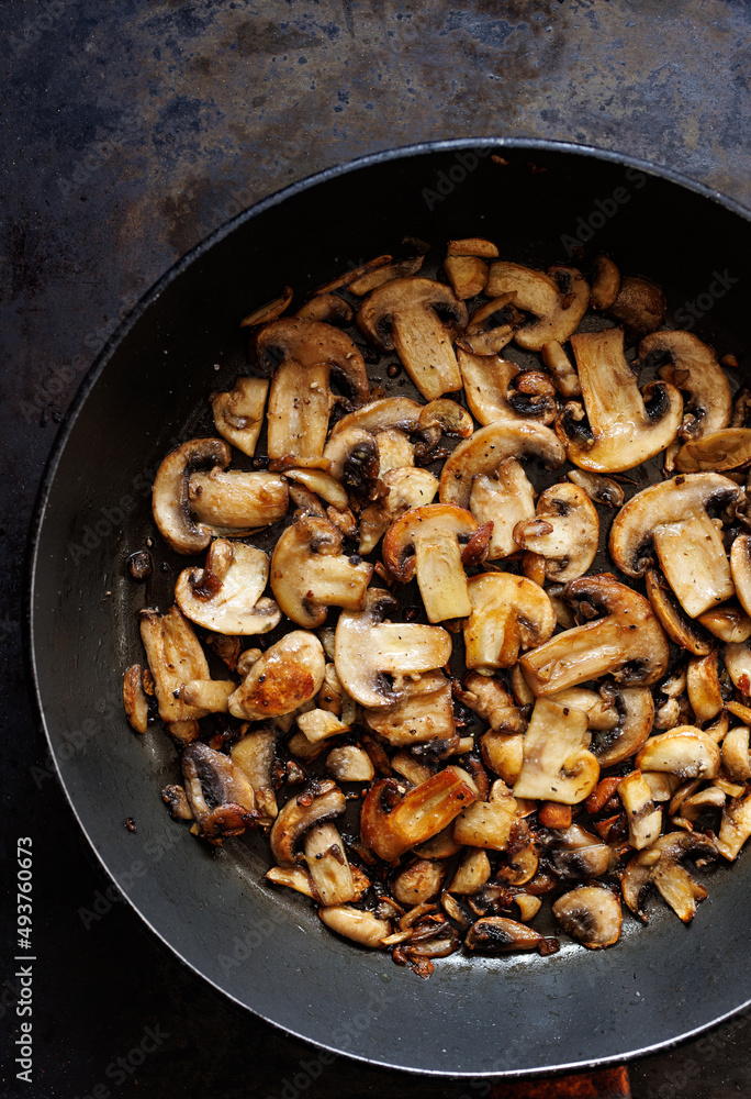 Fried sliced mushrooms in a pan, close up view Fried sliced mushrooms in a pan, close up view